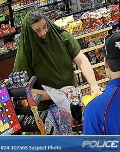 Suspect with a green shirt pulled over his head during a failed robbery at an Esso gas station in Welland, highlighting the importance of security cameras for businesses.