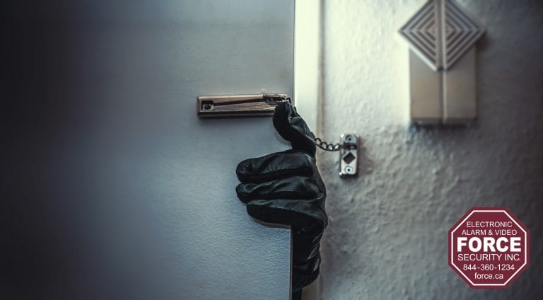 Gloved hand breaking into a home, symbolizing rising break-ins across Ontario, with Force Security logo representing home protection and prevention.