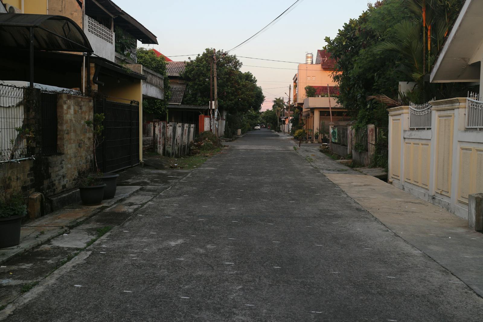 House with empty driveway at dusk, the kind of long-weekend vacancy that signals nobody is home